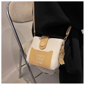 Detail of mini crossbody bucket bag with bear print and adjustable strap in cream and yellow