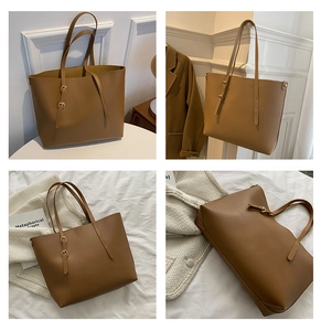Detail view of large brown caramel tote bag with adjustable straps and soft texture