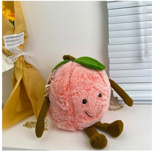 Detail of peach plush bag showing soft pink texture and cute smiley face design