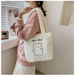 Détail du sac cabas en peluche blanche avec broderie ours bleu et texture douce en fausse fourrure