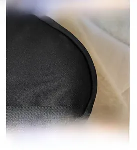Macro view of black pleated nylon fabric with reinforced stitched edge detail
