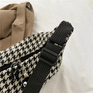 Chic black and white houndstooth crossbody bag with nylon strap and metal zipper