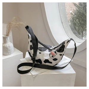 Detailed shot of large nylon cow print crossbody bag with an adjustable wide strap