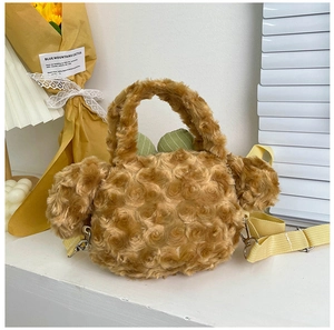 Detail of plush brown bag featuring rose-patterned faux fur texture and cactus leaf accents