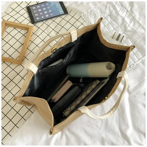 Detail view of large jute tote bag interior with magnetic clasp and spacious inner lining