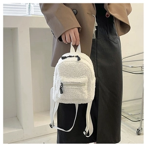 Mini white faux shearling backpack with fluffy texture and adjustable straps detail