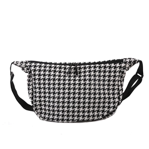 Classic black and white houndstooth crossbody crescent bag with adjustable strap
