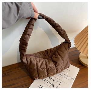 Detail of coffee brown quilted puffer hobo bag with sleek nylon texture and zipper