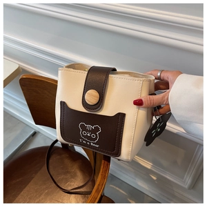 Detail of mini bucket bag with cartoon bear pattern and brown PU leather pocket