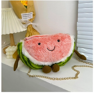 Close-up of watermelon plush bag with embroidered smiley face and corduroy legs