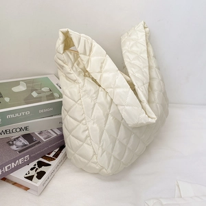 Minimalist cream quilted tote bag with diamond stitching and soft padded shoulder strap
