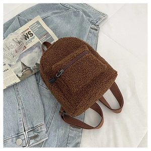 Detailed close-up of a brown teddy fleece mini backpack on casual background