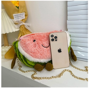 Detailed plush watermelon crossbody bag showing size comparison with a smartphone