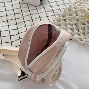 Cute pink and beige crossbody bag with adjustable strap and front pocket detail
