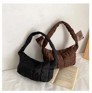 Close-up of quilted shoulder bags in black and brown featuring elegant rhombic stitching