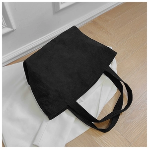 Top view of large black corduroy tote bag showing textured vertical stripe fabric
