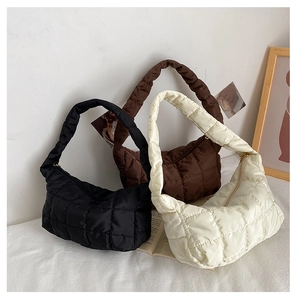 Detailed view of quilted dumpling bags in black, brown, and beige nylon materials