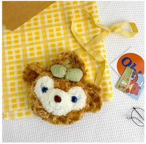 Detail view of the cute bear plush bag featuring a green bow and adjustable yellow strap