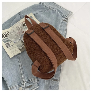 Close-up of soft brown faux shearling texture on a stylish mini backpack with straps