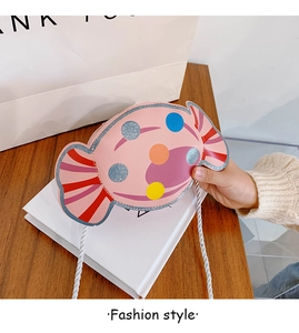 Détail du sac bandoulière rose en forme de bonbon avec pois colorés et cuir PU brillant