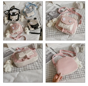 Detail view of cartoon rabbit ear crossbody bags with bear pendant in four pastel colors