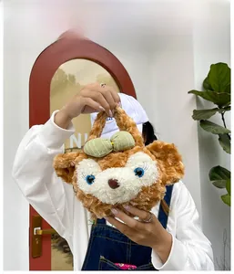 Detail of cute plush crossbody bag with cartoon bear ears and green striped bow decoration