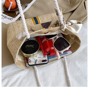 Detail showing the large interior capacity and woven texture of the straw tote bag