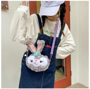 Detail of plush bunny crossbody bag with purple straps and mint green bow decoration