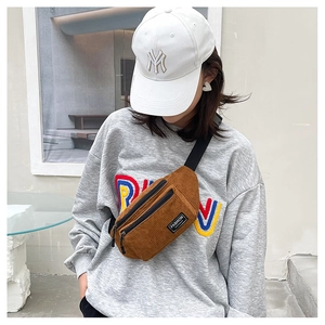 Brown corduroy chest bag featuring vintage striped texture and dual zipper pocket detail