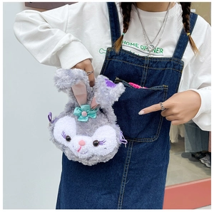 Detail of cute rabbit plush crossbody bag featuring purple ears and green ribbon bow