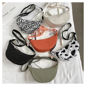 Detailed flat lay of nylon crescent bags in various solid colors and animal prints