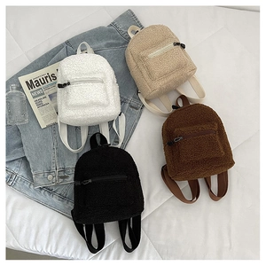 Flat lay of mini teddy fleece backpacks in white, beige, brown, and black colors