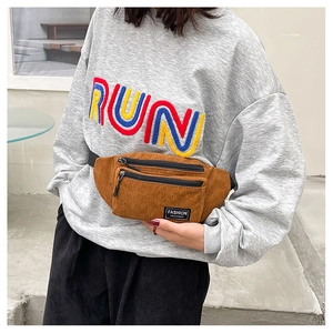 Close-up of brown corduroy waist bag with Fashion Instinct label and zipper detail