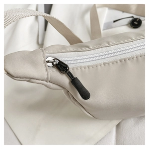 Detailed close-up of nylon chest bag with smooth metal zipper and premium stitching
