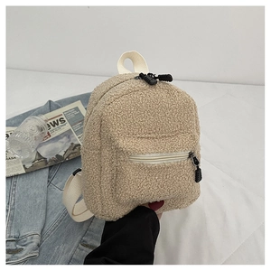 Close-up of khaki faux shearling mini backpack with white straps and metal zipper