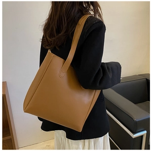 Brown soft leather tote bag for women showing spacious interior and slim shoulder straps