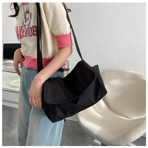 Detail view of large capacity black oxford cloth messenger bag with adjustable strap