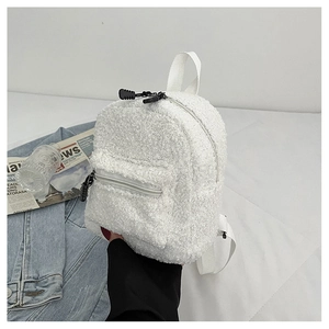 Detail shot of mini faux shearling backpack featuring white plush texture and black zipper pull