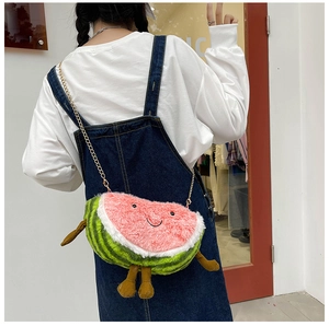 Close-up of a plush watermelon crossbody bag with a cute smiling face and gold chain