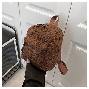 Detailed close-up of brown teddy fleece mini backpack with fuzzy texture and zipper