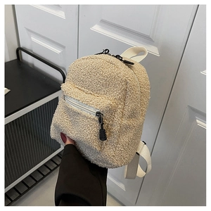 Detailed view of beige sherpa fleece mini backpack with contrast black zippers