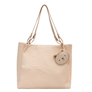 Creamy white embossed tote bag with cartoon bear motifs and golden hardware accents