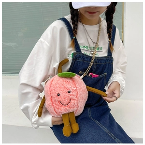 Detail of pink plush peach-shaped crossbody bag with soft faux fur and metal chain strap
