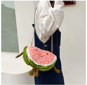 Detail of creative watermelon plush crossbody bag with smiling face and metal chain strap