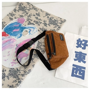 Detail of brown corduroy waist bag with Fashion Instinct label and black zipper