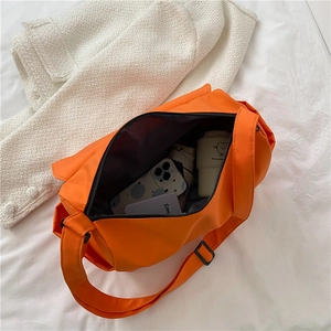 Orange nylon oxford crossbody bag for outdoor sports showing spacious interior storage
