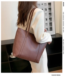 Side view of woman carrying brown quilted PU leather tote bag in a modern room