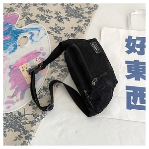 Detail of black corduroy waist bag with double zippers and Fashion Instinct patch