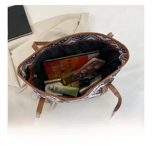 Interior view of large ethnic woven tote bag showing spacious capacity for tablets and cosmetics