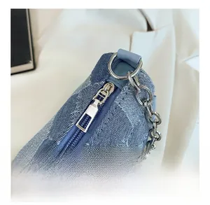 Detail of floral denim texture with silver metal zipper and chunky chain strap